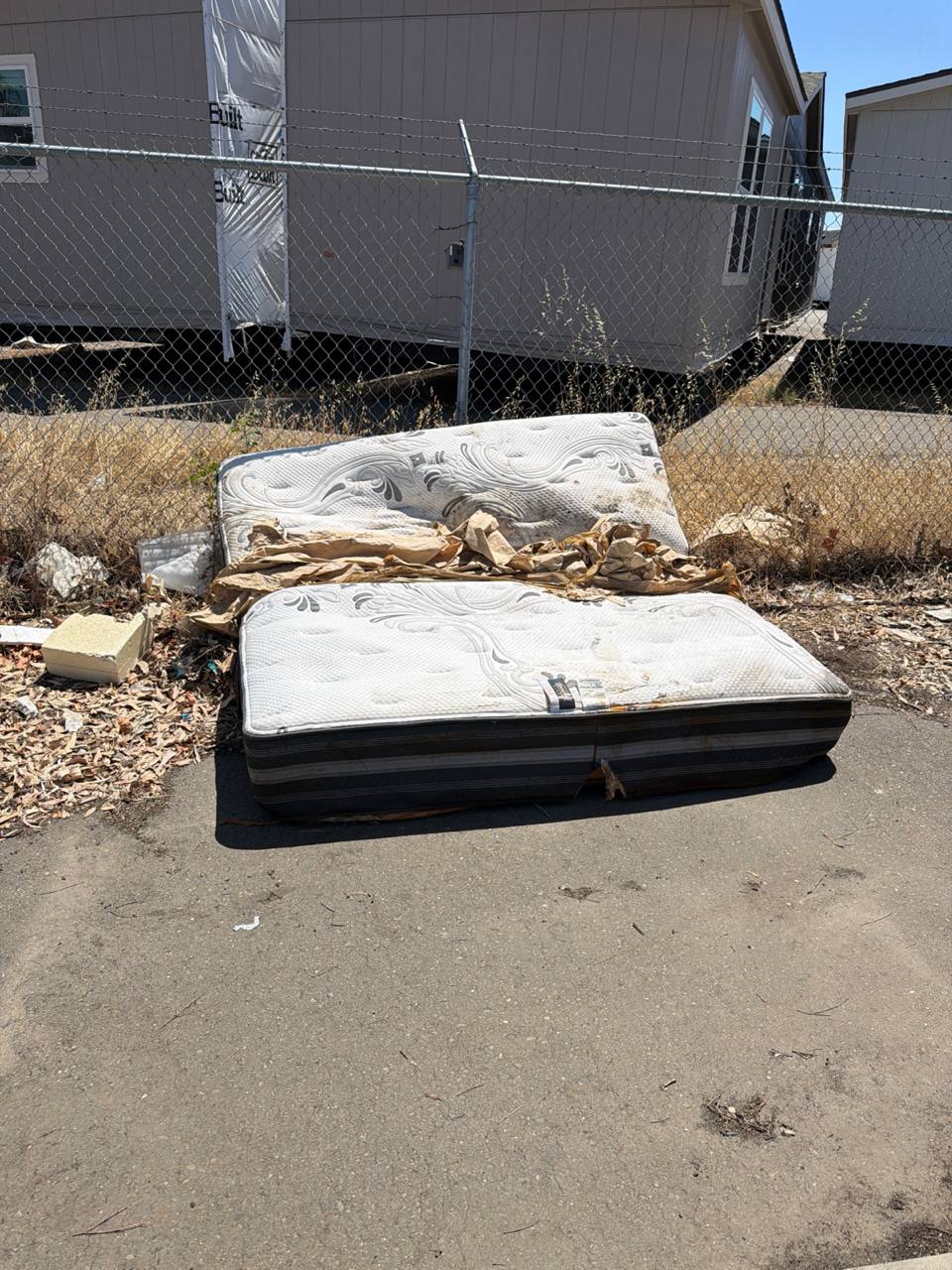Wrapped mattress loaded into MZM Junk Removal truck bed
