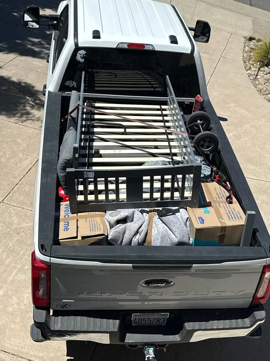 Truck bed loaded with a disassembled bed frame, boxes and moving leftovers hauled away by MZM Junk Removal in Rocklin, CA