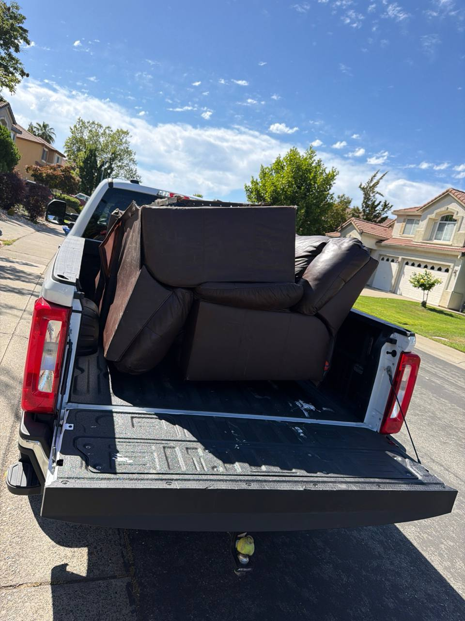 Aerial view of furniture loaded into MZM Junk Removal truck bed